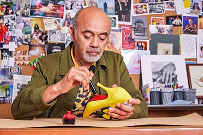 Christian Louboutin painting the sole red
