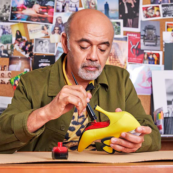 Christian Louboutin painting the sole red